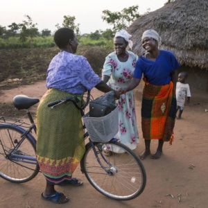 A community mobilizer in Uganda on a home visit