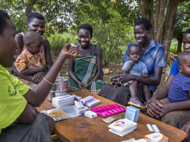 Young mothers getting family planning information from a community health worker in Uganda