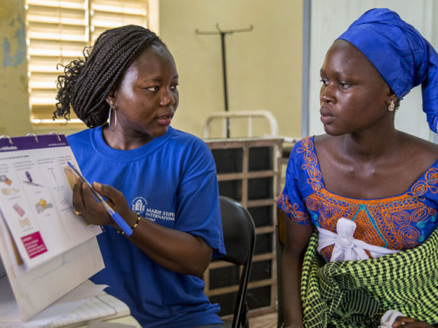 A female health worker provides reproductive health and family planning counseling to a woman