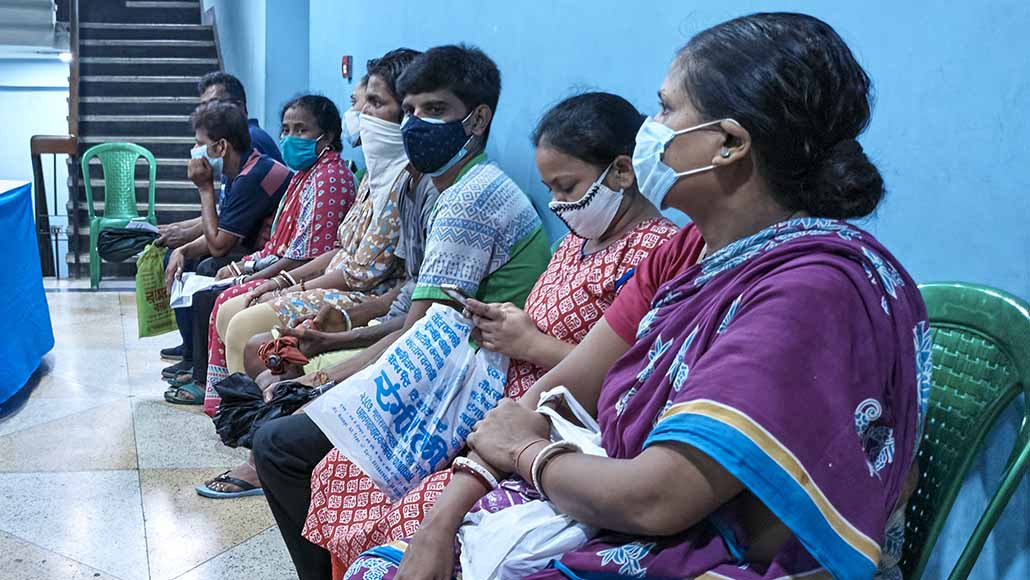People wearing face masks waiting to get the Covid-19 vaccine