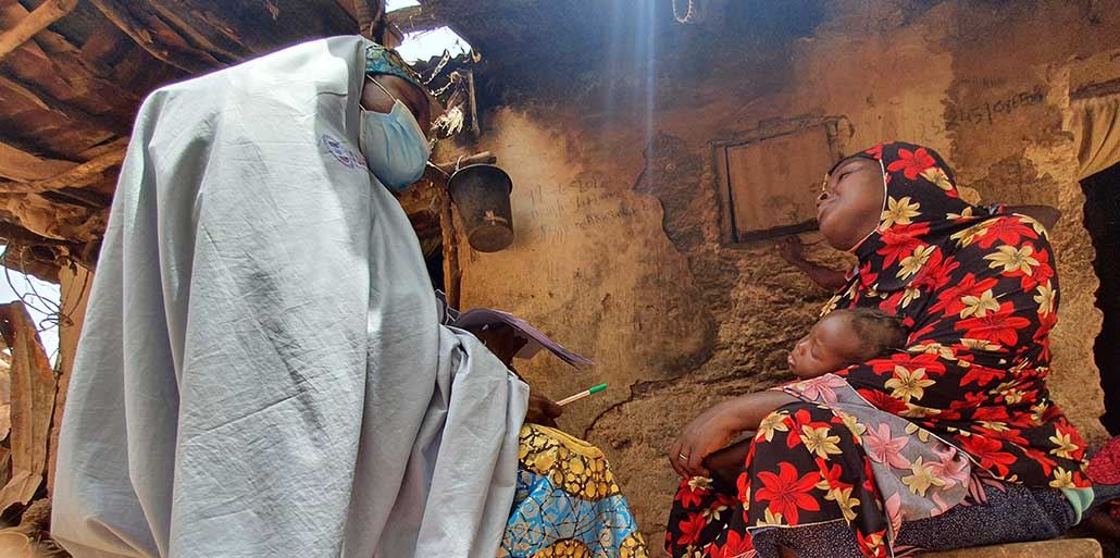 Community Health Worker consults with mother