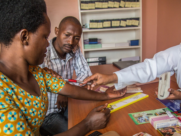 A nurse counsels a couple on family planning in Rwanda