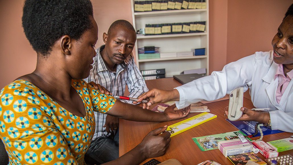 A nurse counsels a couple on family planning in Rwanda